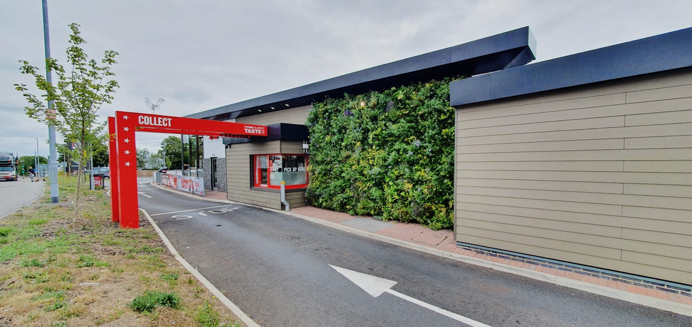 A fast food drive-thru with living wall